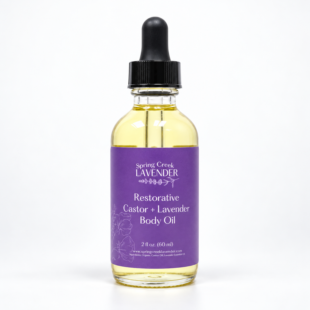 Spring Creek Lavender Restorative Castor + Lavender Body Oil in a 2 oz clear glass dropper bottle with a purple label.