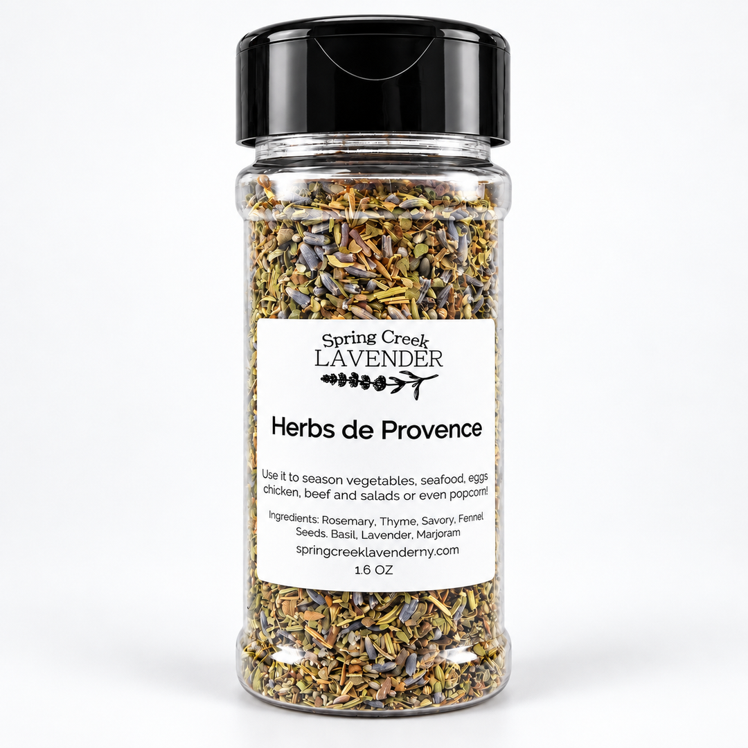 A clear plastic spice jar filled with dried herbs and lavender, topped with a black flip-top lid. The front label reads 'Spring Creek Lavender' and 'Herbs de Provence' on a clean white background.