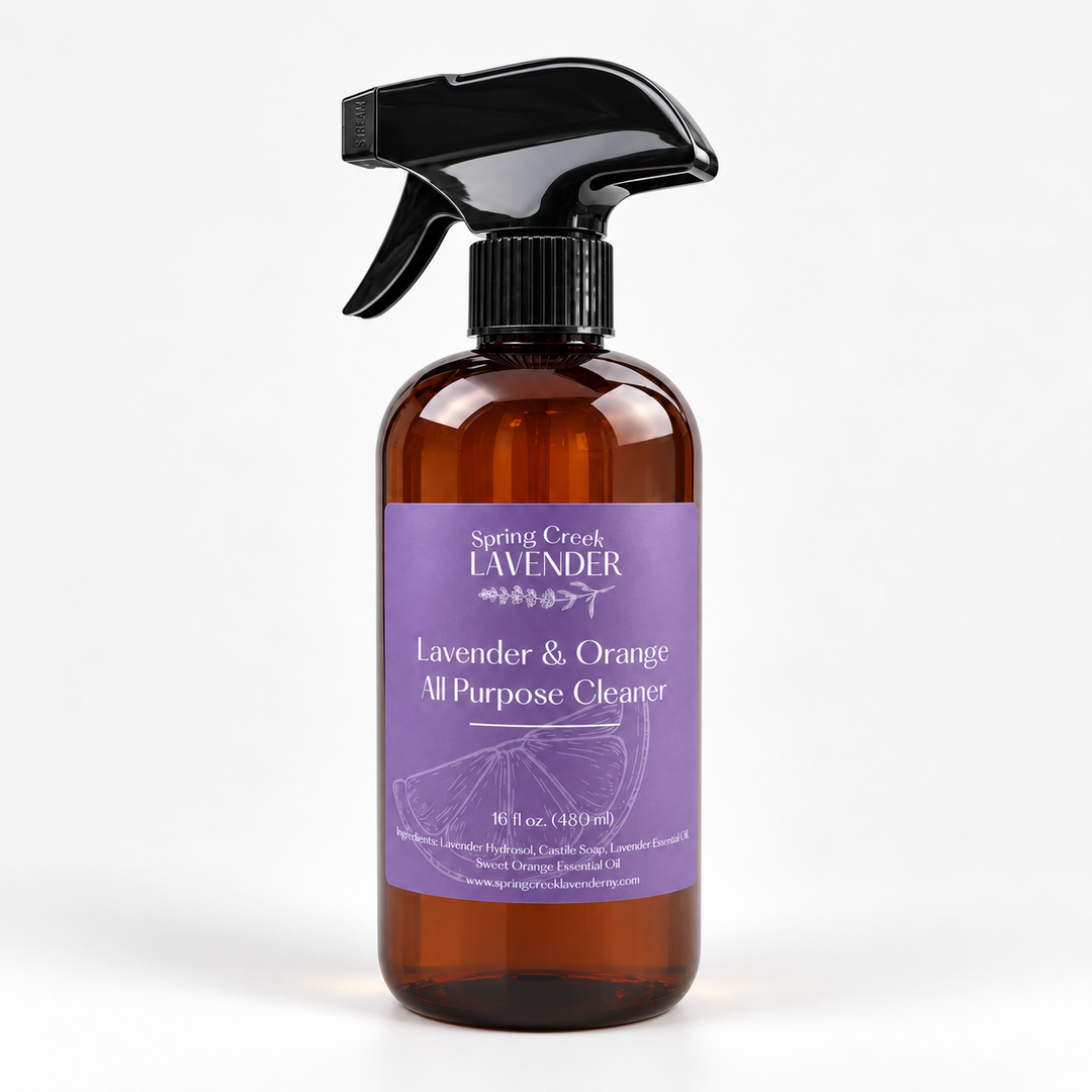 Spring Creek Lavender Lavender & Orange All Purpose Cleaner in a 16 oz amber spray bottle with purple label and black trigger sprayer.
