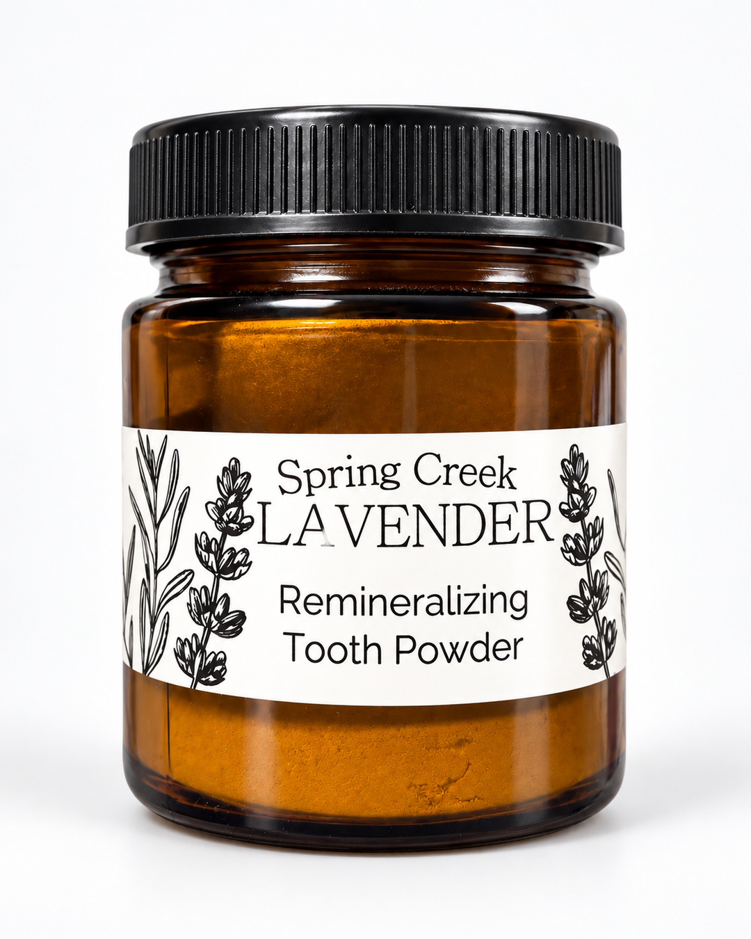 Spring Creek Lavender Remineralizing Tooth Powder in an amber glass jar with black lid and white botanical lavender label.